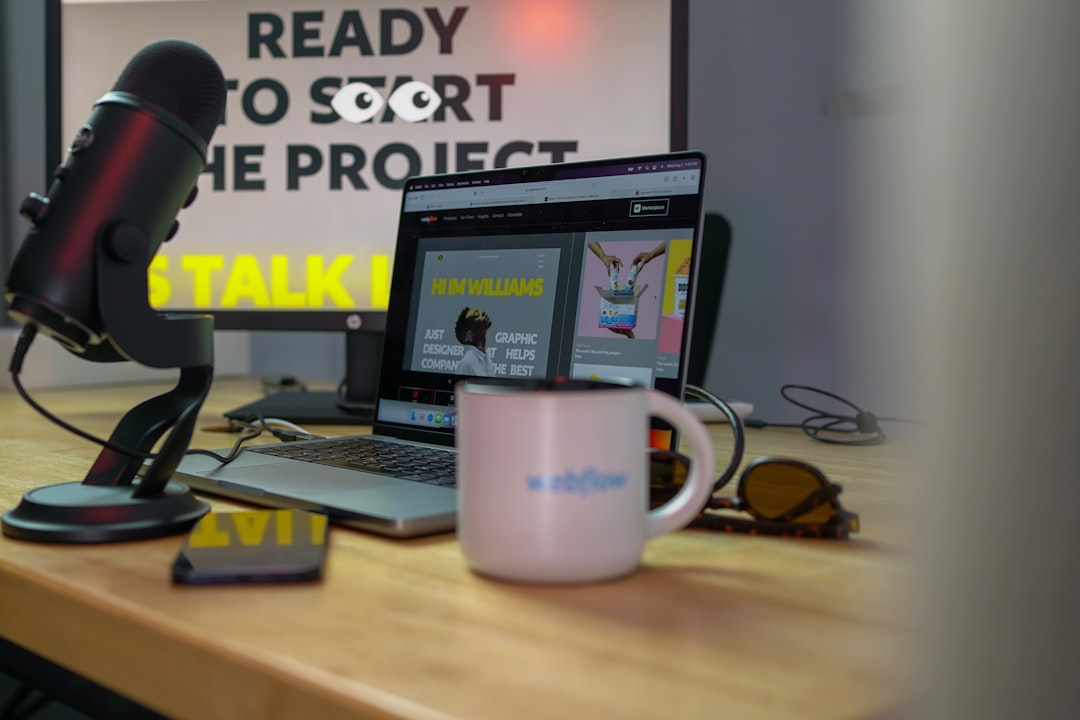 a laptop computer sitting on top of a wooden desk — IL WebDesign Manhattan