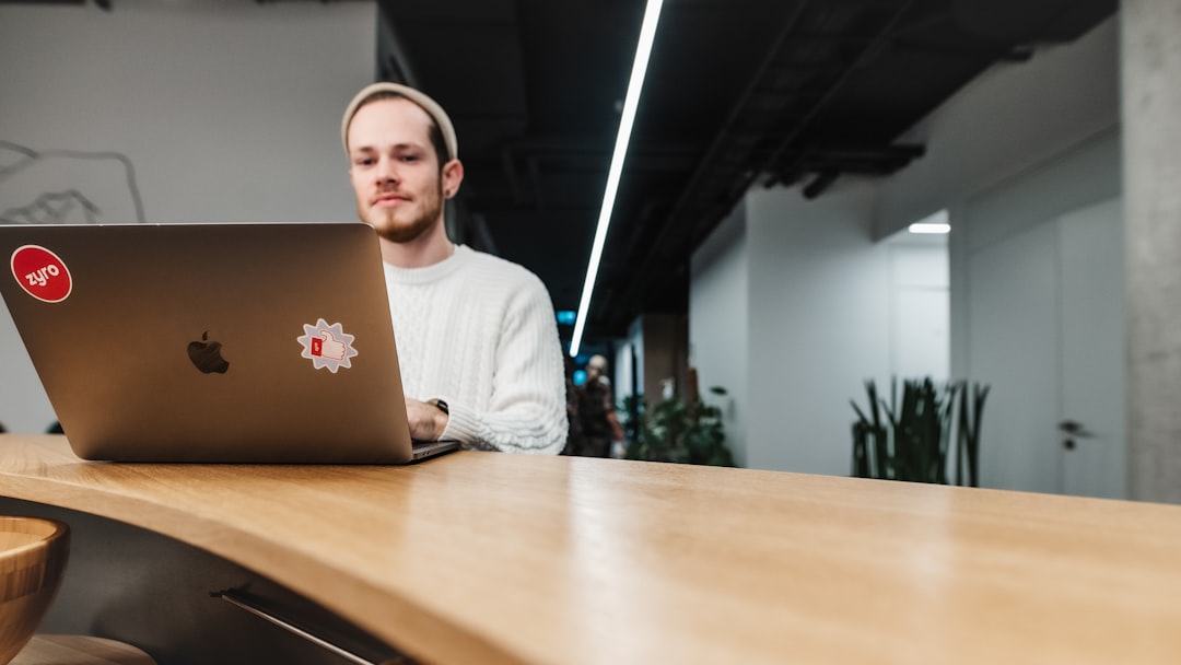 a man sitting in front of a laptop computer — IL WebDesign Manhattan