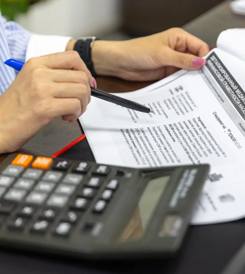 Accountant reviewing a tax document with a calculator