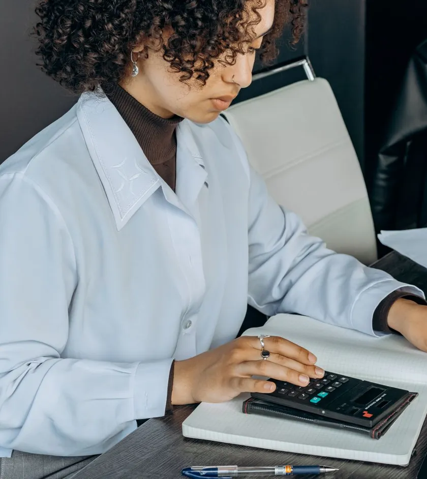 Accountant working with a calculator at a desk