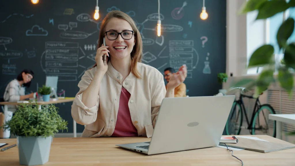 Smiling business owner taking a new customer call from a Google Ads campaign
