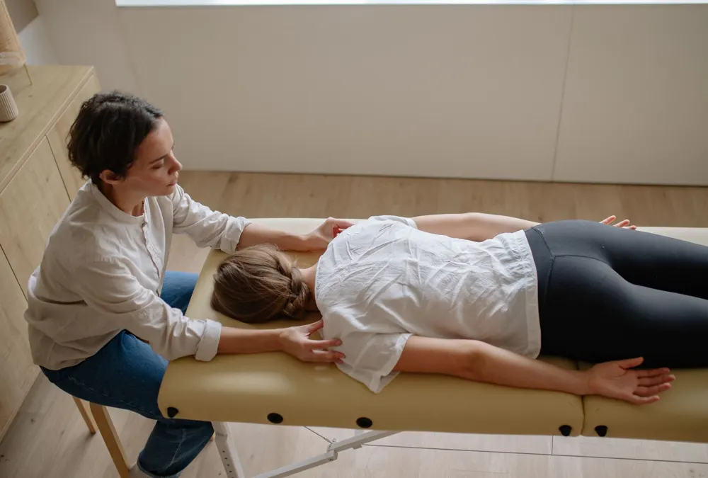 Practitioner treating a patient on a treatment table