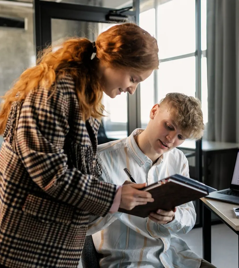 Consulting team reviewing work on a laptop