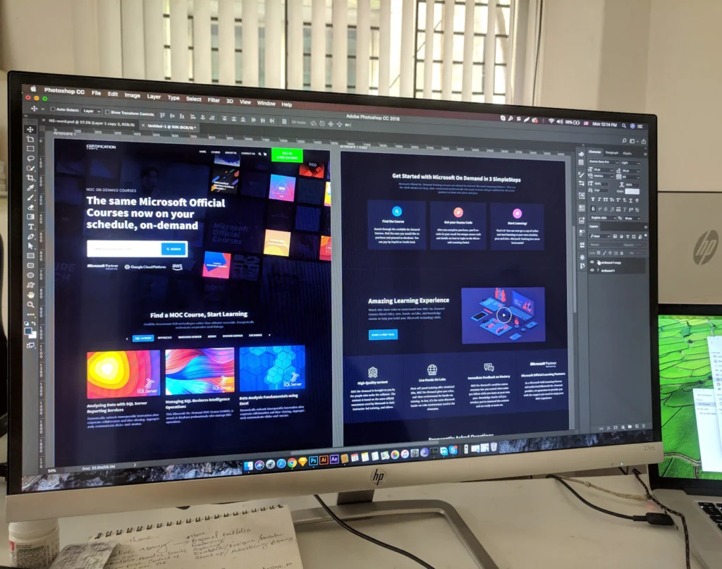 Designer creating a custom website design with brand colors, typography, and page layouts on a large monitor