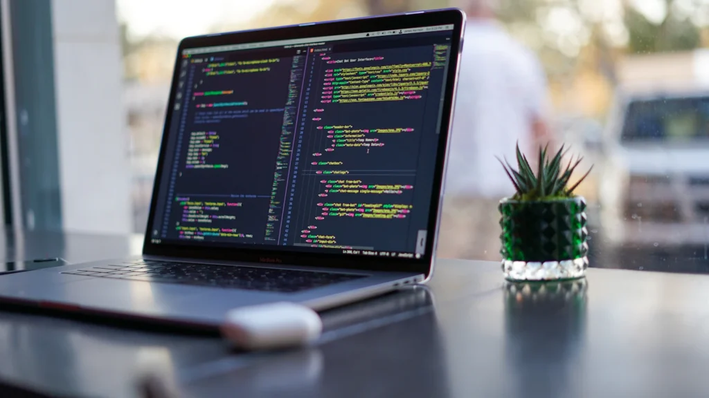 Laptop showing custom WordPress theme code for a responsive business website