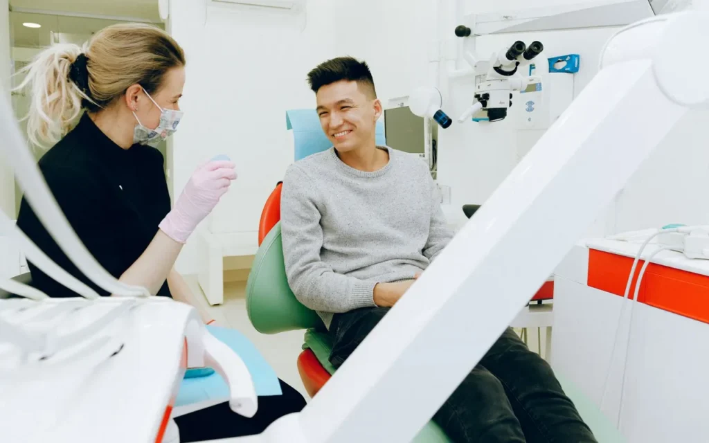 Dental assistant talking with a smiling patient