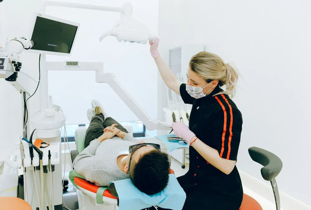 Dental treatment room with dentist and patient