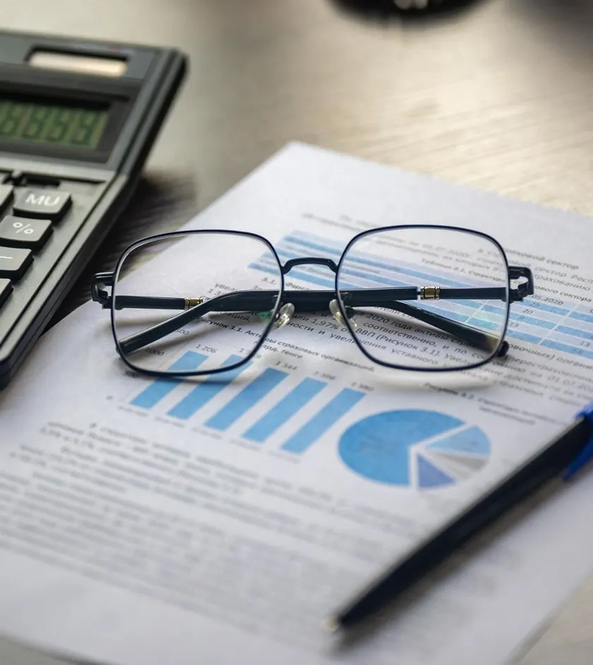 Financial advisor reviewing planning documents at a desk