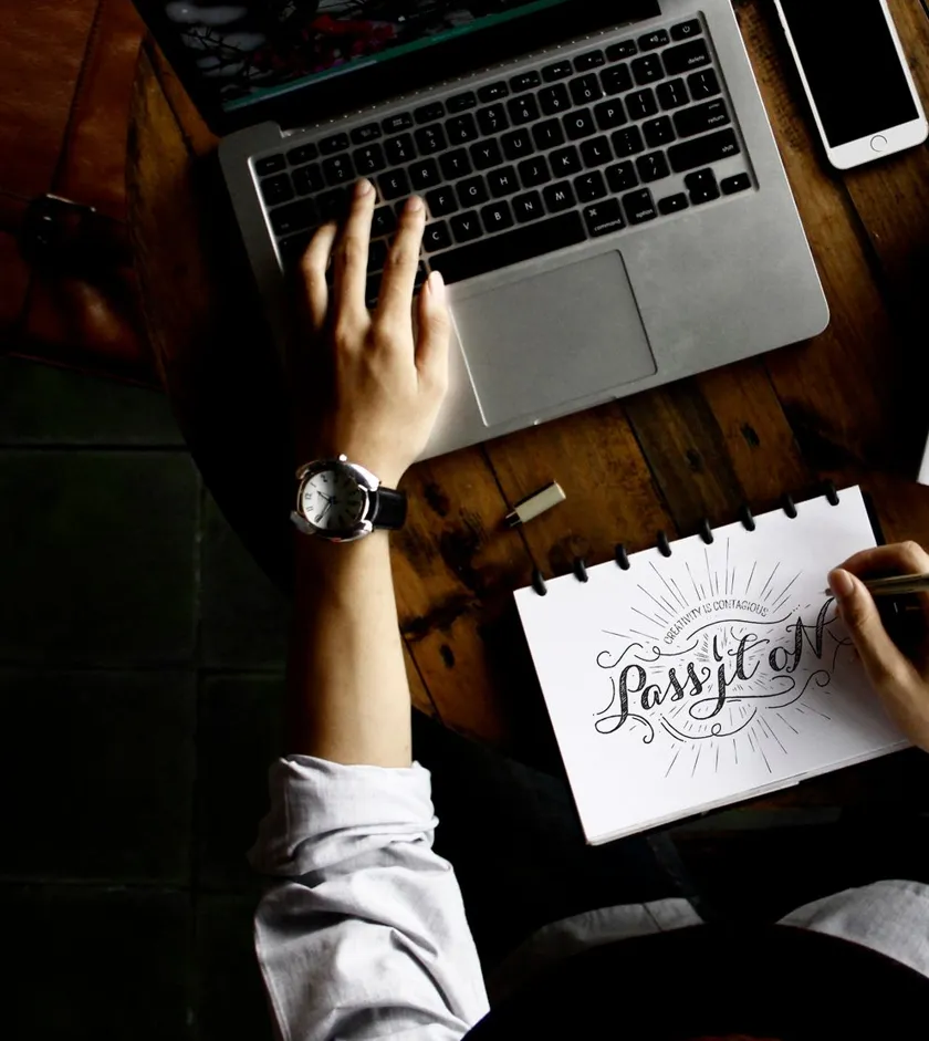 Attorney sketching a custom website layout beside a laptop