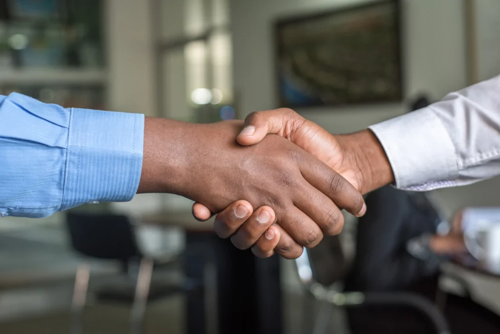 Business partners shaking hands representing link building partnerships and digital PR