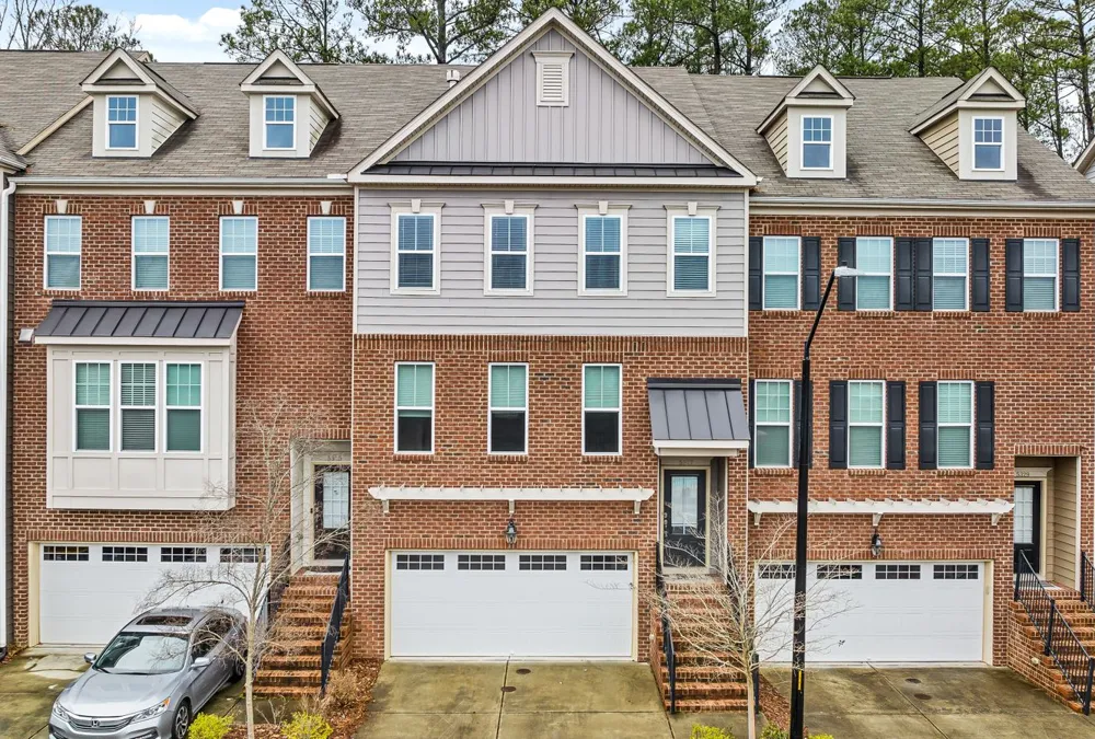 Row of brick townhomes in a residential neighborhood