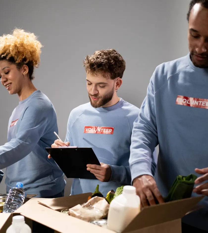 Volunteers sorting fresh food donations into boxes
