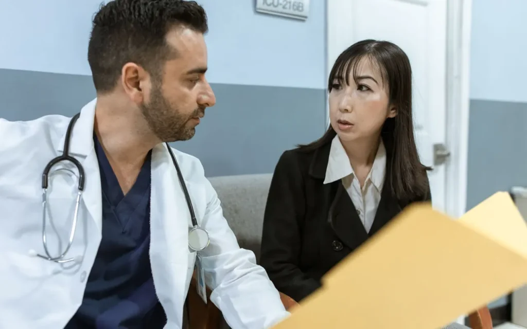 Doctor reviewing a file with a patient in a consultation