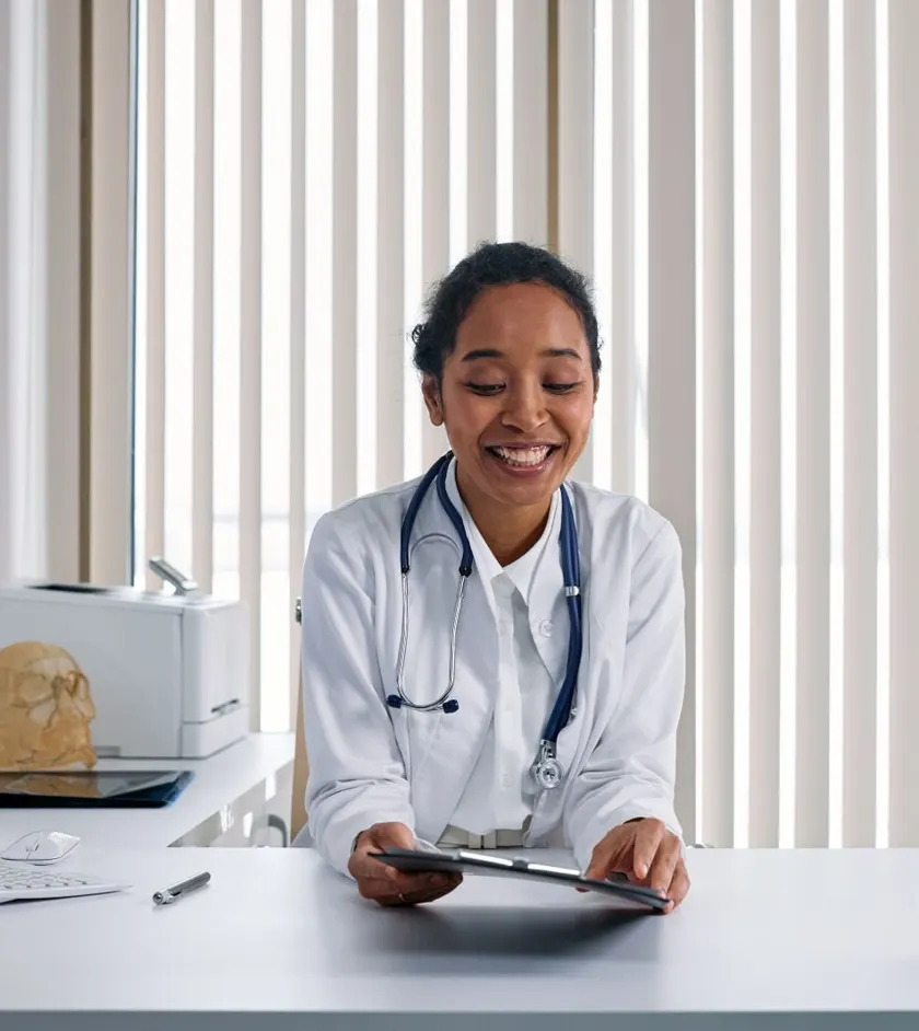 Healthcare provider working at a computer in a clinic
