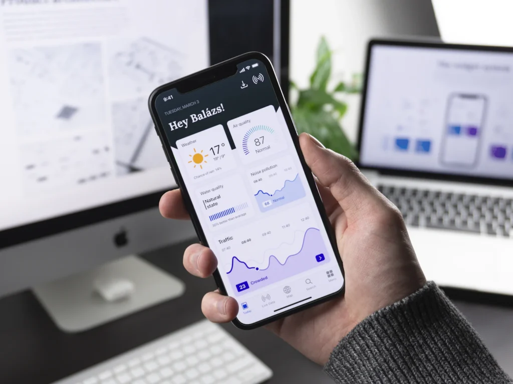 Smartphone and desktop showing a responsive website layout that adapts to every screen size