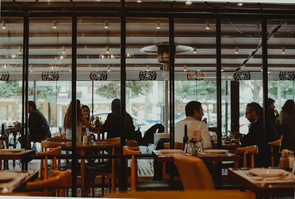 Diners seated in a restaurant seen through large windows