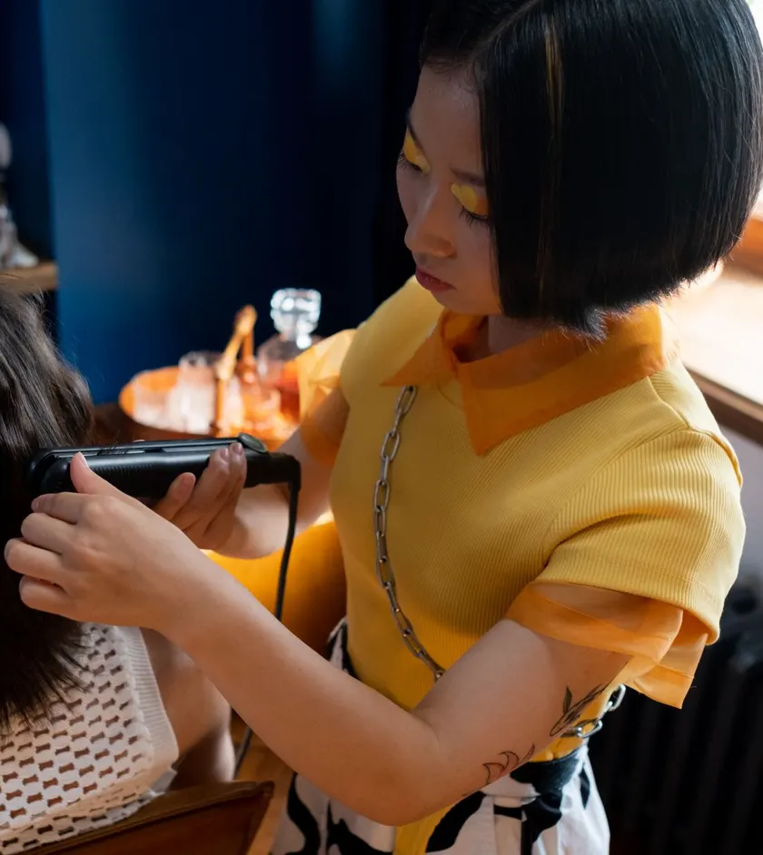 Hairstylist trimming a client’s hair with clippers