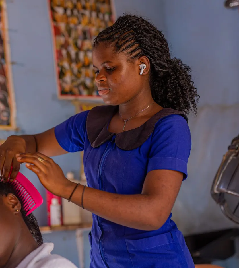 Stylist braiding a client’s hair in a salon