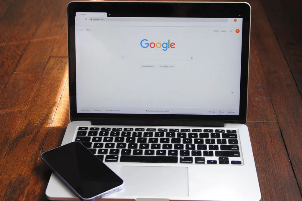 Laptop open to Google search beside a smartphone during an SEO audit and discovery session
