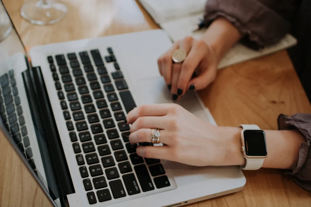 Copywriter typing SEO-optimized website content on a laptop