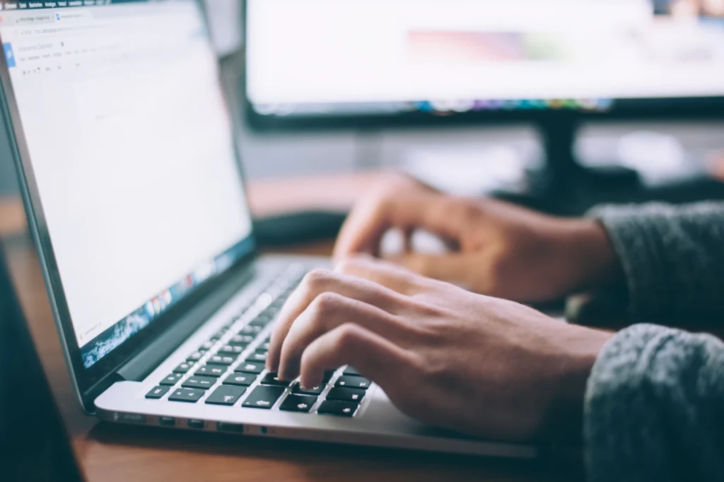 Specialist typing on-page SEO optimizations and technical fixes on a laptop