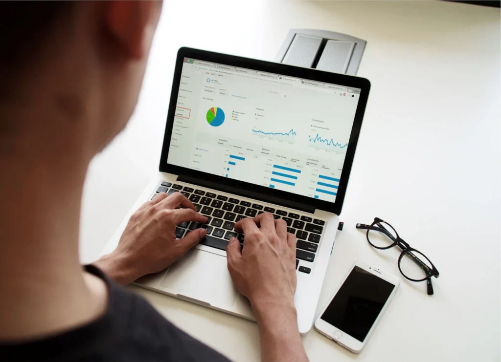Business owner reviewing SEO and lead analytics for a new website on a laptop