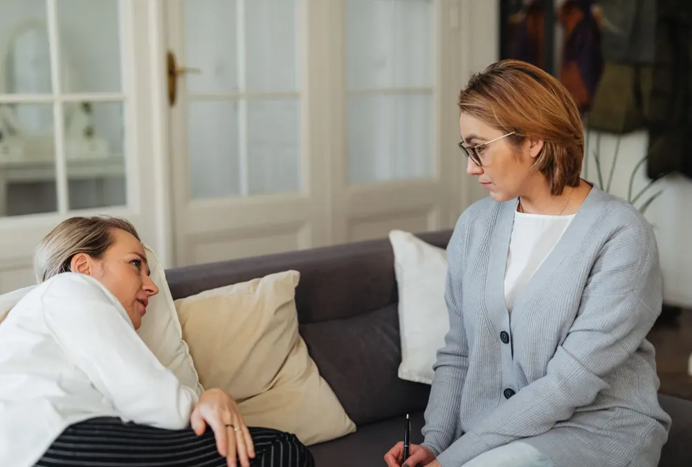 Therapist and client talking on a sofa