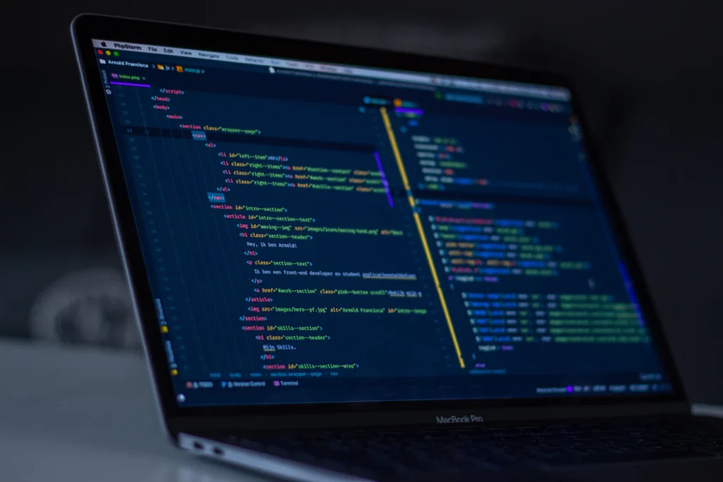 Laptop with website code open during ongoing website maintenance, updates, and security support